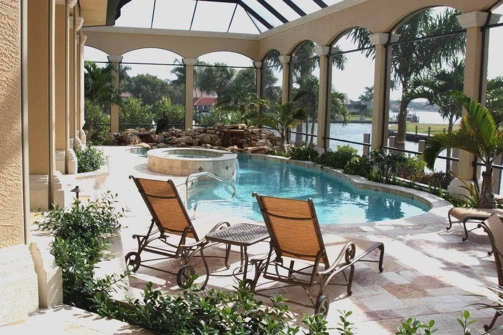 Restored arched pool enclosure with waterfront view in Palm Beach County FL