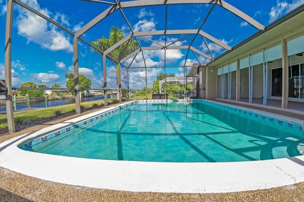 Aluminum pool cage framing over a screened pool in Palm Beach County FL